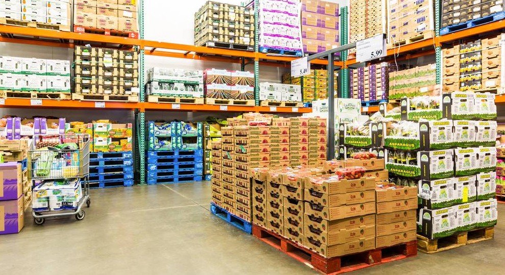 Large food wholesale warehouse with stacked pallets and shelves supplying bulk food products for restaurants and catering businesses in the UK