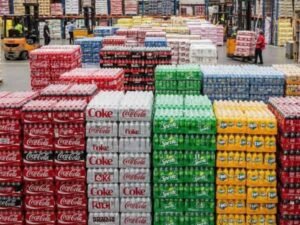 Bulk soft drinks including Coca-Cola, Sprite, Fanta and bottled water stored in a wholesale warehouse for restaurants, cafés and retailers in Walsall.