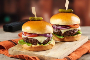 Brioche burger buns with juicy beef patties, cheese, lettuce, tomato and onions