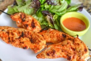 Peri peri grilled chicken fillets served with fresh salad and spicy dipping sauce