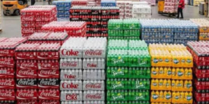 Bulk soft drinks including Coca-Cola, Sprite, Fanta and bottled water stored in a wholesale warehouse for restaurants, cafés and retailers in Walsall.